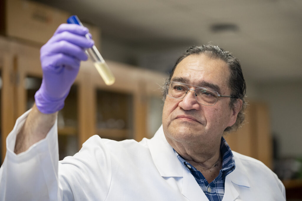 Dr. Alex Castillo holding a test tube