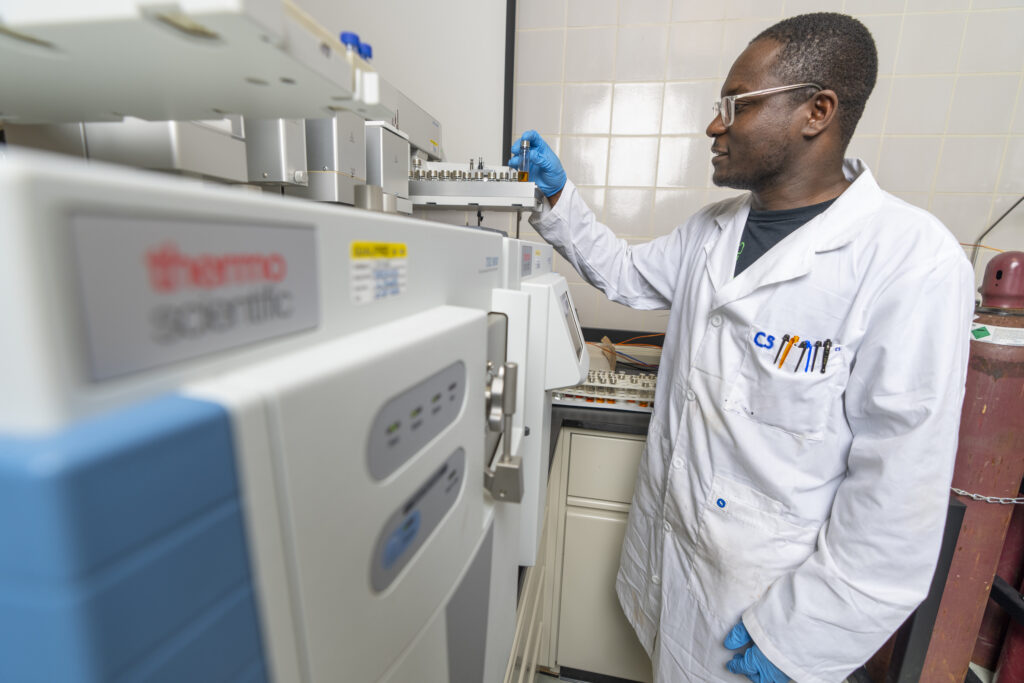 Student in lab inspecting a vial