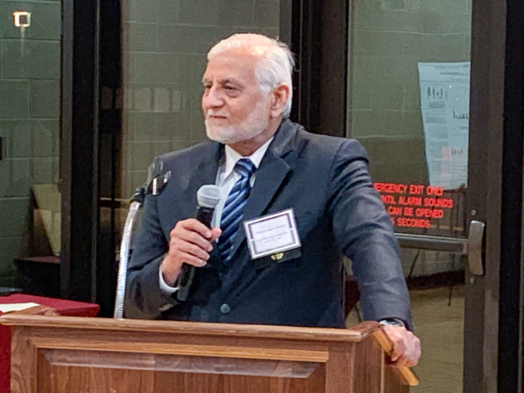 man in suit speaking at podium
