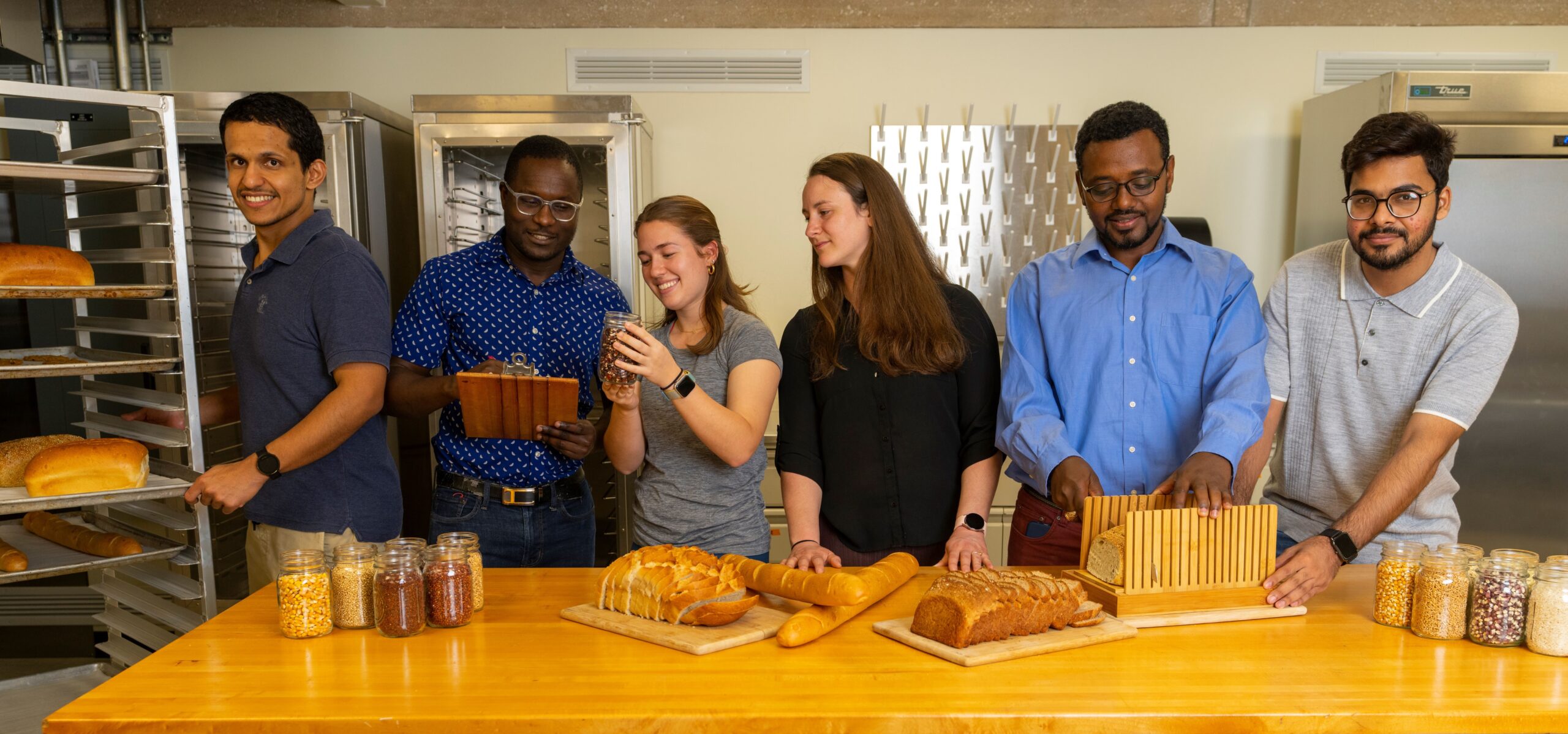 a group of students preparing different kinds of bread